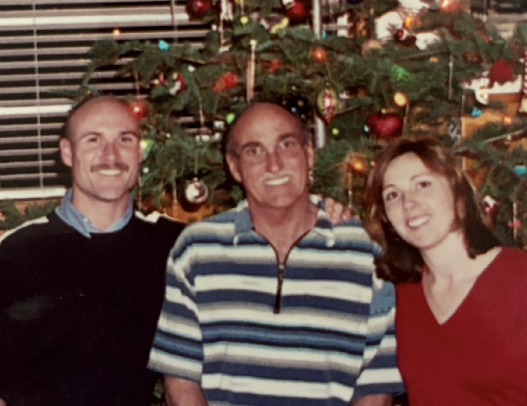 Stephen McDougle with family in front of a Christmas tree